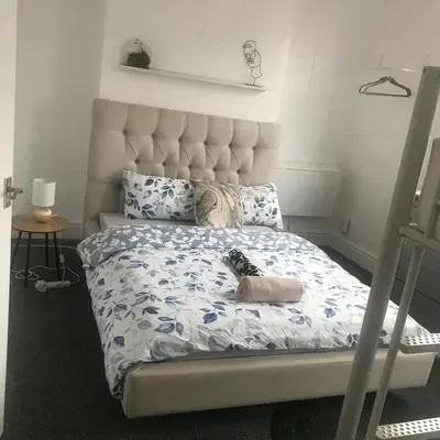 a bedroom with a bed with a stuffed animal on it at Noble Prestige Place in Liverpool