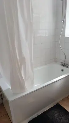 a white bath tub with a shower curtain at Noble Prestige Place in Liverpool