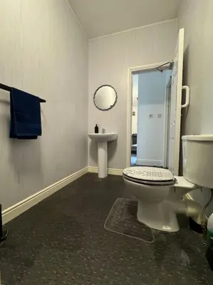 a bathroom with a toilet and a sink at Subway Apartments in Blackpool