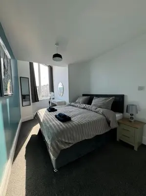 a bedroom with a large bed in a room at Subway Apartments in Blackpool