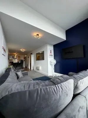 a living room with a couch and a blue wall at Subway Apartments in Blackpool
