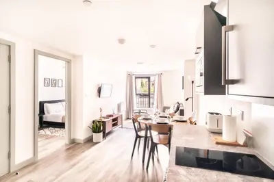 a kitchen and living room with a table and chairs at Fabulous 1 Bed Apartment in Liverpool Centre in Liverpool