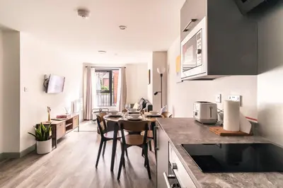 a kitchen and dining room with a table and chairs at Fabulous 1 Bed Apartment in Liverpool Centre in Liverpool