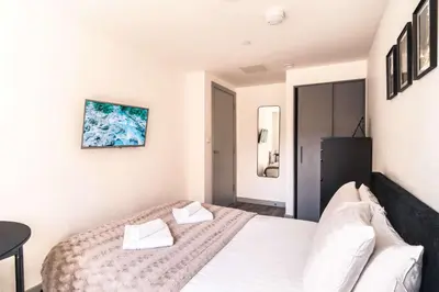 a bedroom with a white bed with two white pillows at Fabulous 1 Bed Apartment in Liverpool Centre in Liverpool
