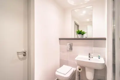 a bathroom with a sink and a toilet and a mirror at Fabulous 1 Bed Apartment in Liverpool Centre in Liverpool