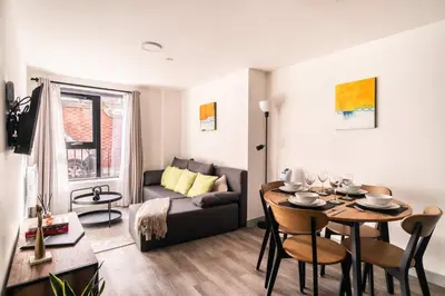 a living room with a table and a couch at Fabulous 1 Bed Apartment in Liverpool Centre in Liverpool