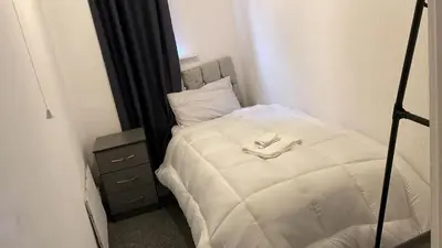 a bedroom with a white bed with a towel on it at Great House 5 Min walk 2 Beach best locations in Blackpool in Blackpool