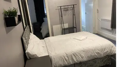 a small bed in a room with a mirror at Great House 5 Min walk 2 Beach best locations in Blackpool in Blackpool