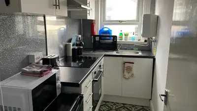 a small kitchen with a sink and a stove at Great House 5 Min walk 2 Beach best locations in Blackpool in Blackpool