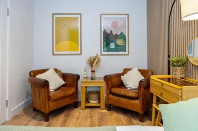 a living room with two chairs and a table at GuestReady - Georgian Quarter retreat with terrace in Liverpool