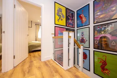 a hallway with a wall of pictures on the wall at GuestReady - Georgian Quarter retreat with terrace in Liverpool