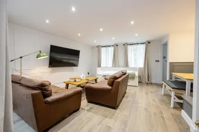 a living room with two couches and a table at GuestReady - Georgian Quarter retreat with terrace in Liverpool