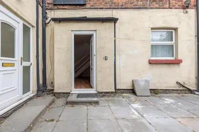 an open door of a building next to a building at Cheerful Maisonette in the heart of Orrell Park in Liverpool