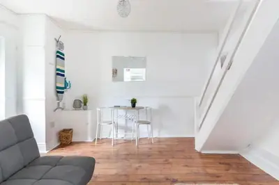 a living room with a couch and a table at Cheerful Maisonette in the heart of Orrell Park in Liverpool