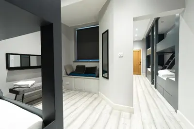 a bedroom with two beds and a large window at Charles Alexander Short Stay - Vibe Apartments in Blackpool