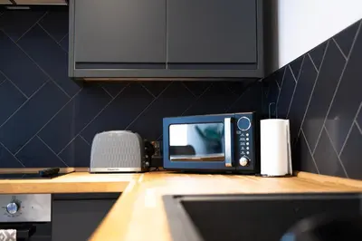 a microwave sitting on top of a counter in a kitchen at Charles Alexander Short Stay - Vibe Apartments in Blackpool