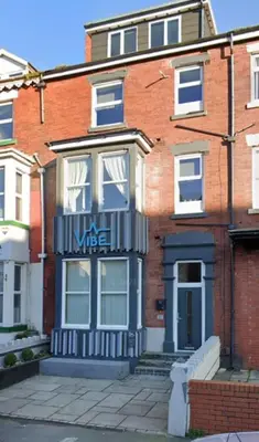 a brick building with a sign on the front of it at Charles Alexander Short Stay - Vibe Apartments in Blackpool