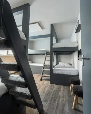 a room with a staircase and bunk beds at Charles Alexander Short Stay - Vibe Apartments in Blackpool