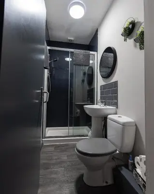 a bathroom with a toilet and a sink and a shower at Charles Alexander Short Stay - Vibe Apartments in Blackpool