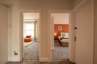 a room with a bedroom with a bed and a couch at Britannia Apartments in Liscard Village Wallasey by Rework Accommodation in Wallasey