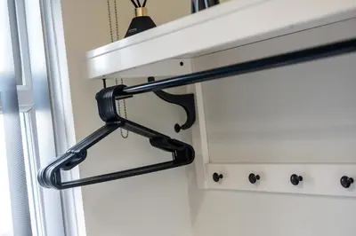 a black curtain rod hanging from a window at Anfield Cosy Stays - Air Host & Stay - Sleeps 14 in Liverpool