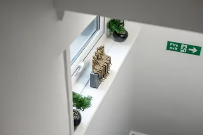 a window sill with plants and a lion statue on it at Anfield Cosy Stays - Air Host & Stay - Sleeps 14 in Liverpool
