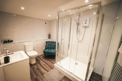 a bathroom with a shower and a toilet at The Old Lambing Barn in Longton