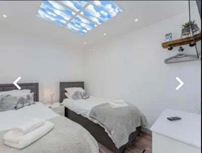 a bedroom with two beds with towels on them at The Cow Shed in Longton