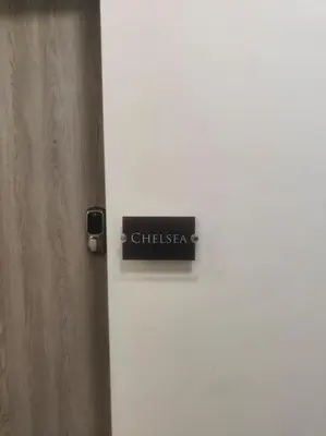 a white door with a sign on it at Chelsea 2 bedroom promenade apartment in Blackpool