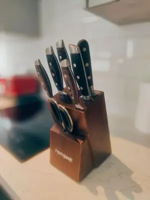 a wooden knife block holding a bunch of knives at Chelsea 2 bedroom promenade apartment in Blackpool