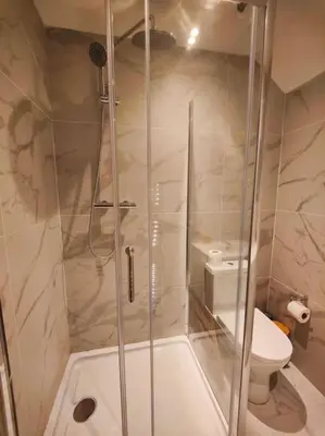 a bathroom with a shower and a toilet at Chelsea 2 bedroom promenade apartment in Blackpool