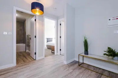 a living room with a bed and a table at Elysée Suites - Stunning 2 Bed Flat in Southport in Southport