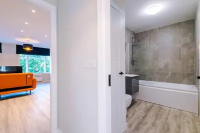 a bathroom with a shower and a toilet and a sink at Elysée Suites - Stunning 2 Bed Flat in Southport in Southport
