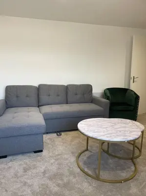 a living room with a couch and a table at Balmoral Stays 6 - Studio Apartment by Pleasure Beach in Blackpool