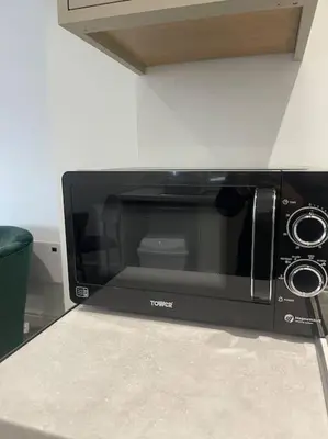 a microwave oven sitting on top of a counter at Balmoral Stays 6 - Studio Apartment by Pleasure Beach in Blackpool