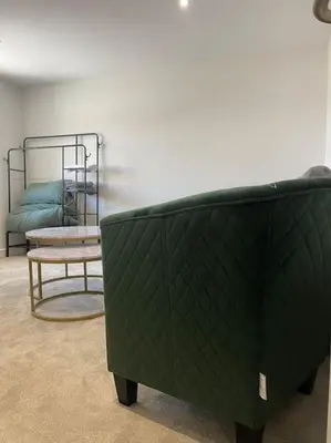 a green couch and a chair in a room at Balmoral Stays 6 - Studio Apartment by Pleasure Beach in Blackpool