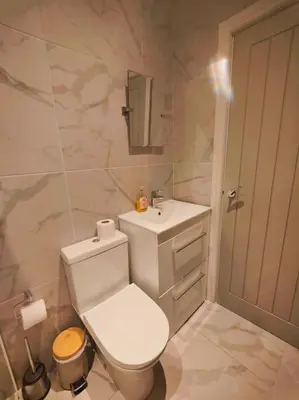 a white bathroom with a toilet and a sink at Sloane modern 2 bedroom seafront Apartment in Blackpool