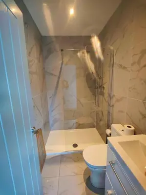 a bathroom with a shower and a toilet at Sloane modern 2 bedroom seafront Apartment in Blackpool