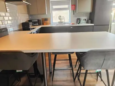 a kitchen with a large table and two chairs at Sloane modern 2 bedroom seafront Apartment in Blackpool