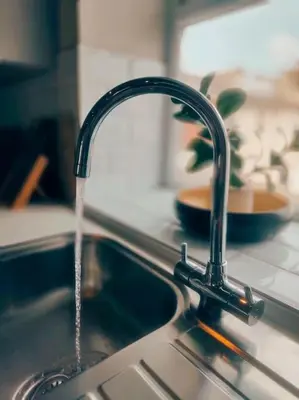 a kitchen sink with water running from a faucet at Sloane modern 2 bedroom seafront Apartment in Blackpool