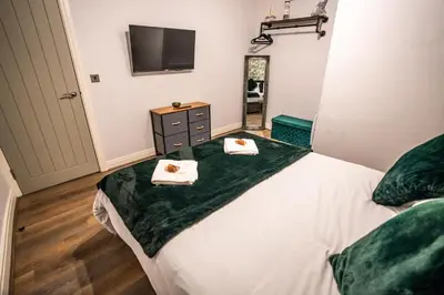 a bedroom with a bed with two towels on it at Belgravia Duplex Seaview Apartment in Blackpool
