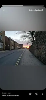 an empty street with a sunset in the distance at Station Guesthouse - Self entry via keypad inc parking in Lancaster