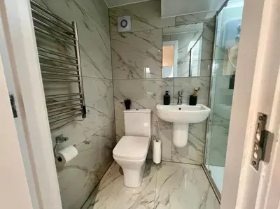 a white bathroom with a toilet and a sink at 2 Bed Preston City Centre Flat - Sleeps 4 with parking in Preston