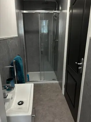 a small bathroom with a shower and a sink at Apartment Twenty4 Blackpool in Blackpool
