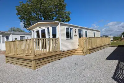 a tiny house with a porch and a fence at Luxe 6 berth caravan Lytham in Weeton