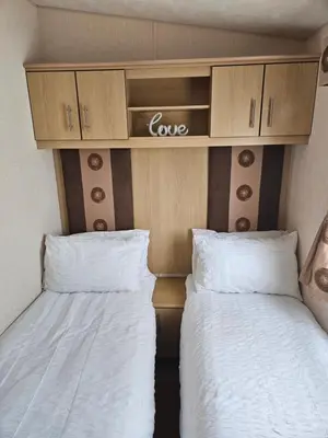 two beds in a small room with white sheets at Luxe 6 berth caravan Lytham in Weeton
