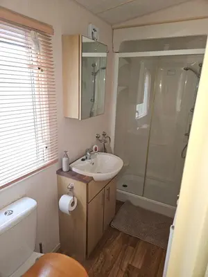 a bathroom with a sink and a shower at Luxe 6 berth caravan Lytham in Weeton