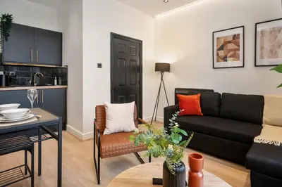 a living room with a couch and a table at Lombana Apt 4 - City Centre - Parking in Liverpool