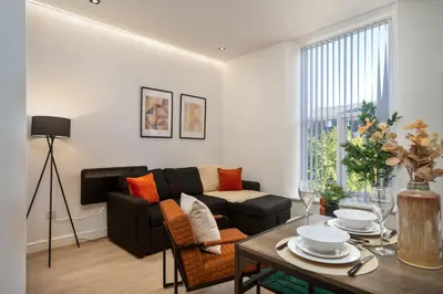 a living room with a couch and a table at Lombana Apt 4 - City Centre - Parking in Liverpool