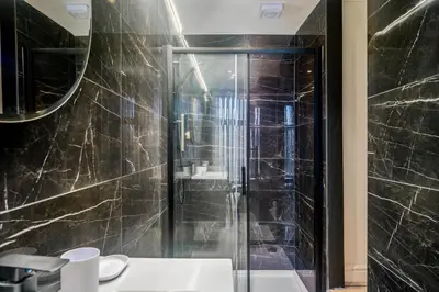 a bathroom with a glass shower and a sink at Lombana Apt 4 - City Centre - Parking in Liverpool
